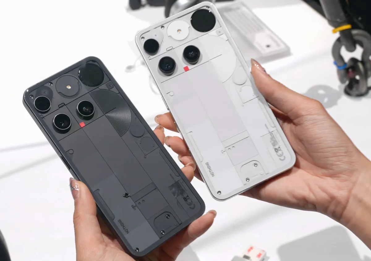 Nothing Phone (3) in black and in white, back views, held in hand at a hands-on event